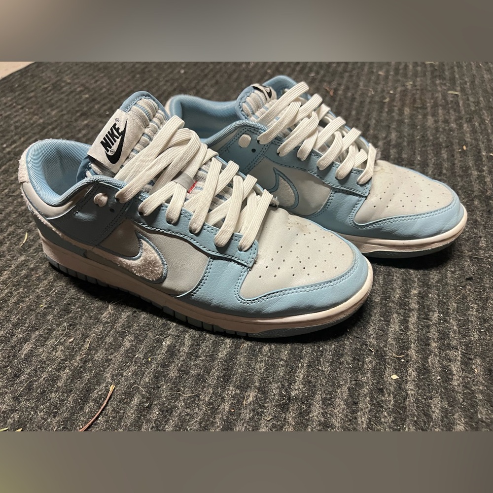 Men’s blue and gray Nike dunks with furry logo
